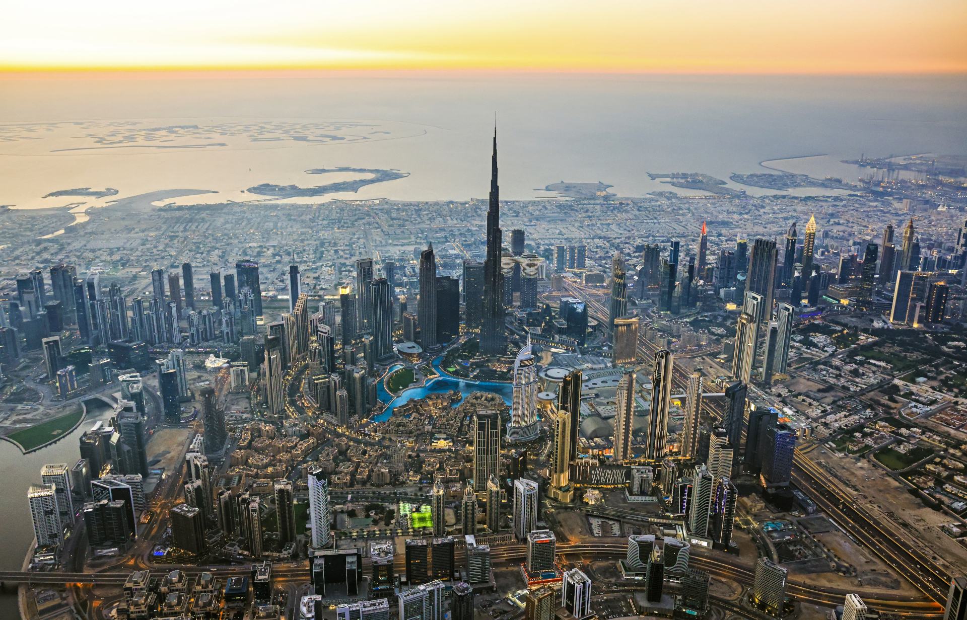 Aerial view of the Dubai skyline with the Burj Khalifa at sunrise